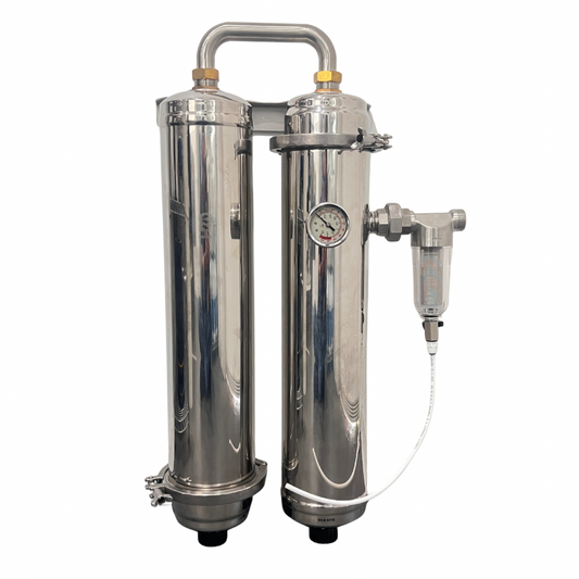 A stainless steel dual-cylinder water filter system with a top piping handle, pressure gauges, and an attached filter cartridge, shown against a plain white background.